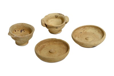 Lot 69 - A GROUP OF FOUR MINIATURE TERRACOTTA VOTIVE...