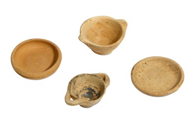 Lot 70 - A GROUP OF FOUR MINIATURE TERRACOTTA VOTIVE...