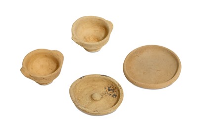 Lot 73 - A GROUP OF FOUR MINIATURE TERRACOTTA VOTIVE...
