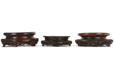 Lot 246 - THREE CHINESE CIRCULAR WOOD STANDS. 19th /...