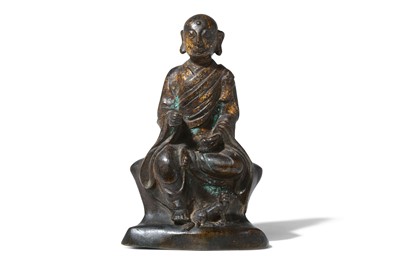 Lot 142 - A CHINESE PARCEL-GILT BRONZE FIGURE OF A...