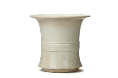 Lot 75 - A CHINESE CREAM-GLAZED VASE, GU. The waisted...