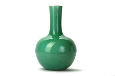 Lot 514 - A CHINESE APPLE GREEN-GLAZED BOTTLE VASE. Late...