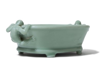 Lot 84 - A CHINESE CELADON-GLAZED 'CHILONG' BRUSH...