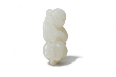 Lot 447 - A CHINESE WHITE JADE CARVING OF A MONKEY. With...