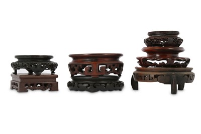 Lot 230 - SEVEN CHINESE WOOD STANDS. Carved with pierced...