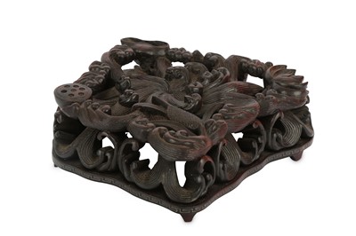 Lot 260 - A CHINESE 'WAVES AND LOTUS' WOOD STAND. Carved...