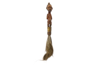 Lot 820 - A FIGURAL FLY WHISK  The brush surmounted by a...