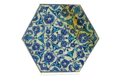 Lot 113 - A BLUE AND WHITE HEXAGONAL IZNIK POTTERY TILE