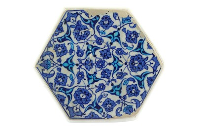 Lot 112 - A BLUE AND WHITE HEXAGONAL IZNIK POTTERY TILE