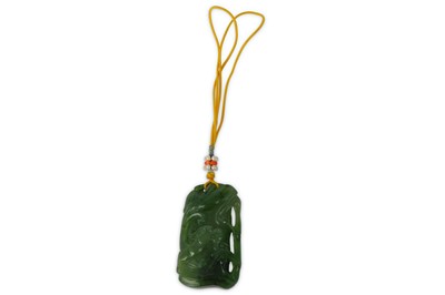 Lot 186 - A CHINESE SPINACH-GREEN JADE ‘DRAGON ON BAMBOO’ PENDANT.