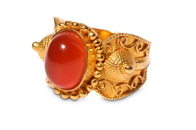 Lot 329 - A hardstone dress ring, set with an oval...