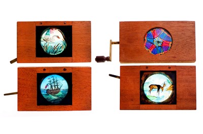 Lot 333 - A GROUP OF MECHANICAL MAHOGANY MAGIC LANTERN...