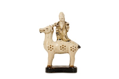 Lot 414 - A CHINESE POTTERY FIGURE OF SHOULAO ON A DEER