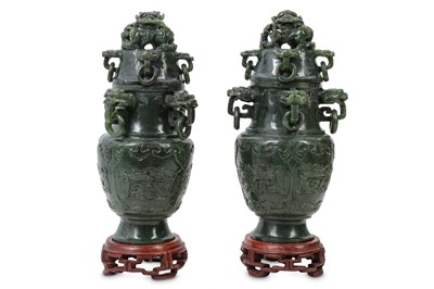 Lot 559 - A PAIR OF CHINESE SPINACH JADE 'DRAGON' VASES AND COVERS.