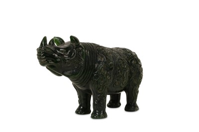 Lot 43 - A CHINESE SPINACH GREEN JADE 'RHINOCEROS' CARVING.