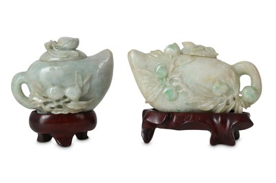 Lot 554 - TWO CHINESE APPLE-GREEN JADEITE 'PEACH' TEAPOTS AND COVERS.