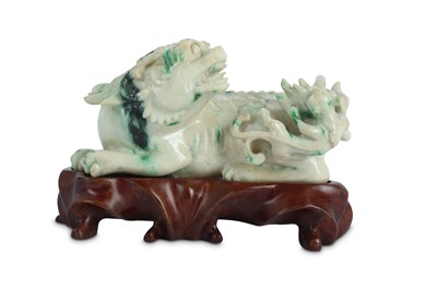 Lot 506 - A CHINESE APPLE-GREEN JADEITE CARVING OF A QILIN