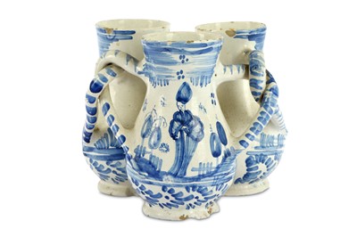 Lot 60 - A German fayence blue and white fuddling cup,...