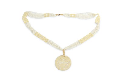 Lot 227 - A Chinese celadon jade pendant, of circular...