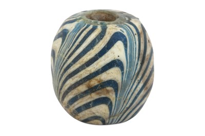 Lot 78 - A LARGE MARVERED GLASS NECKLACE BEAD