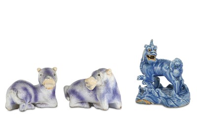 Lot 339 - A CHINESE BLUE-GLAZED BISCUIT MODEL OF A QILIN  AND A PAIR OF PURPLE-GLAZED ANIMALS.