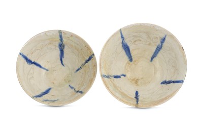Lot 122 - *A NEAR PAIR OF WHITE-GLAZED BLUE-SPLASHED KASHAN POTTERY BOWLS