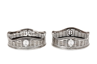 Lot 438 - A pair of George III sterling silver wine coasters, marks rubbed, London 1777