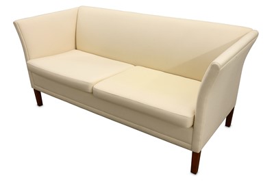 Lot 364 - A Danish two seater sofa with cream fabric...