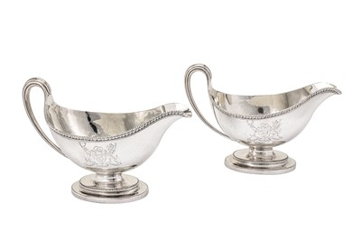 Lot 576 - A pair of George III sterling silver sauce boats, London 1784 by Edward Wakelin and William Taylor (reg. 25th Sep 1776)