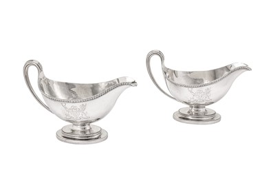 Lot 576 - A pair of George III sterling silver sauce boats, London 1784 by Edward Wakelin and William Taylor (reg. 25th Sep 1776)