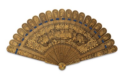 Lot 129 - A CHINESE GILT BLACK LACQUER FOLDING FAN.