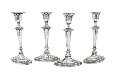 Lot 386 - A set of four George V sterling silver candlesticks, Sheffield 1910 by James Deakin & Sons