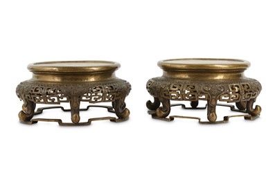 Lot 398 - A PAIR OF TIBETAN BRONZE CIRCULAR STANDS.