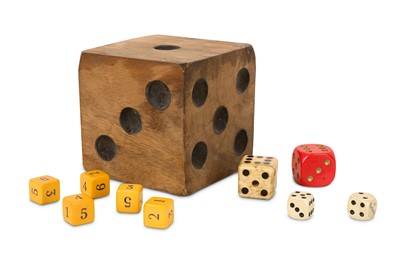 Lot 132 - AN OVER-SIZED CARVED AND STAINED WOODEN DICE TOGETHER WITH NINE OTHERS