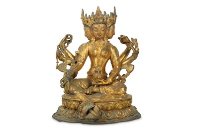 Lot 448 - A CHINESE GILT-BRONZE SEATED FIGURE OF THREE-FACED VASUDHARA.