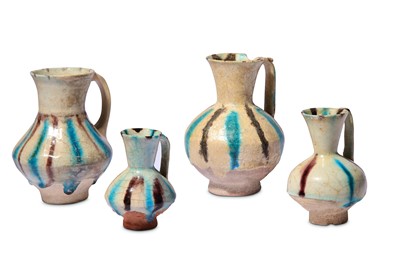 Lot 6 - * FOUR SMALL SPLASHED KASHAN POTTERY EWERS