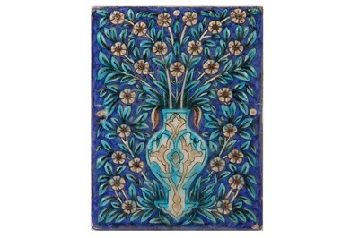 Lot 22 - * A QAJAR MOULDED POTTERY TILE WITH FLORAL MOTIF