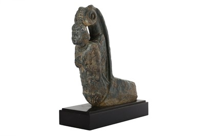 Lot 159 - A GREY SCHIST GARLAND HOLDER WITH A WINGED CELESTIAL