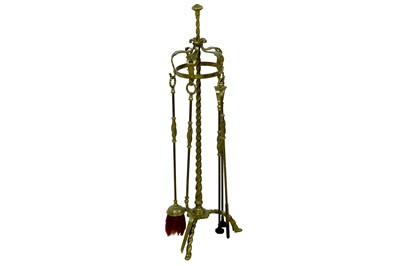 Lot 485 - An early 20th Century Continental brass fireside companion set