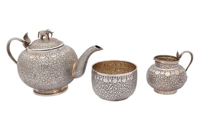 Lot 210 - A THREE-PIECE INDIAN SILVER TEA SET