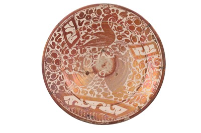 Lot 180 - AN HISPANO-MORESQUE COPPER-LUSTRE POTTERY DISH