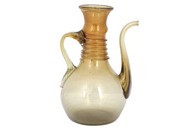 Lot 280 - A CLEAR AMBER-COLOURED MUGHAL GLASS EWER