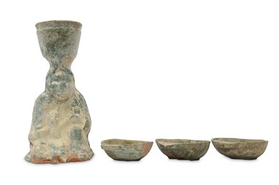 Lot 422 - A CHINESE GREEN-GLAZED POTTERY CANDLESTICK AND THREE 'EAR' CUPS