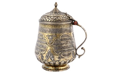 Lot 221 - A SILVER-GILT REPOUSSÉ LIDDED TANKARD