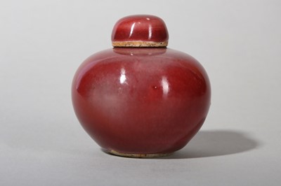 Lot 130 - A SMALL CHINESE COPPER RED-GLAZED JAR AND COVER.