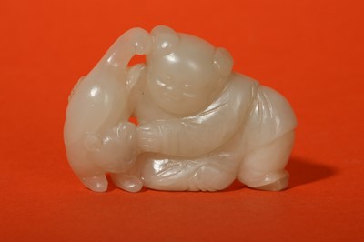 Lot 88 - A CHINESE WHITE JADE 'BOY AND CAT' GROUP.
