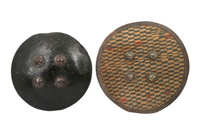 Lot 405 - A BRAIDED STRAW CEREMONIAL SHIELD AND A LEATHER SHIELD