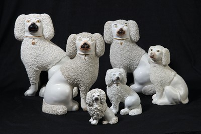 Lot 217 - A pair of large mid 19th century Staffordshire porcelain seated poodles