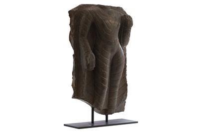 Lot 313 - A BLACK STONE TORSO OF A STANDING BUDDHA